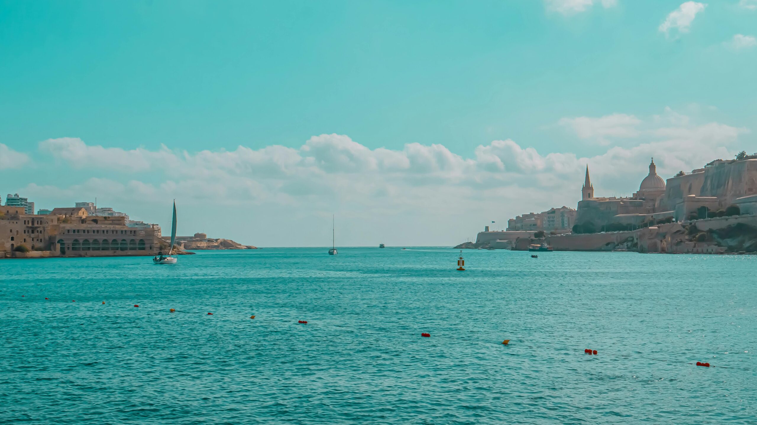 Tranquil seascape showcasing Malta's stunning historic harbor with vibrant blue waters.