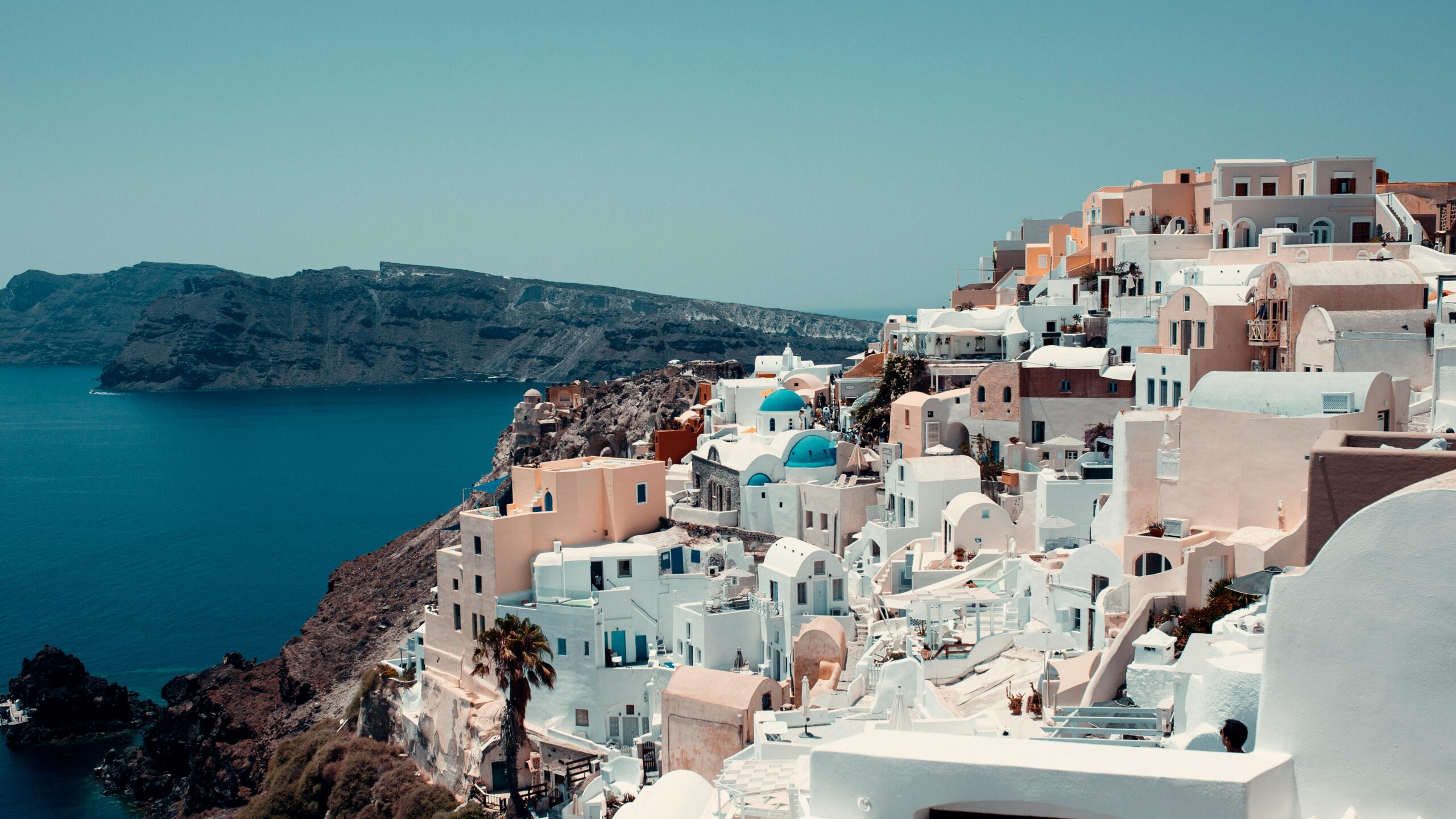 Breathtaking view of iconic white-washed buildings on Santorini's coast.